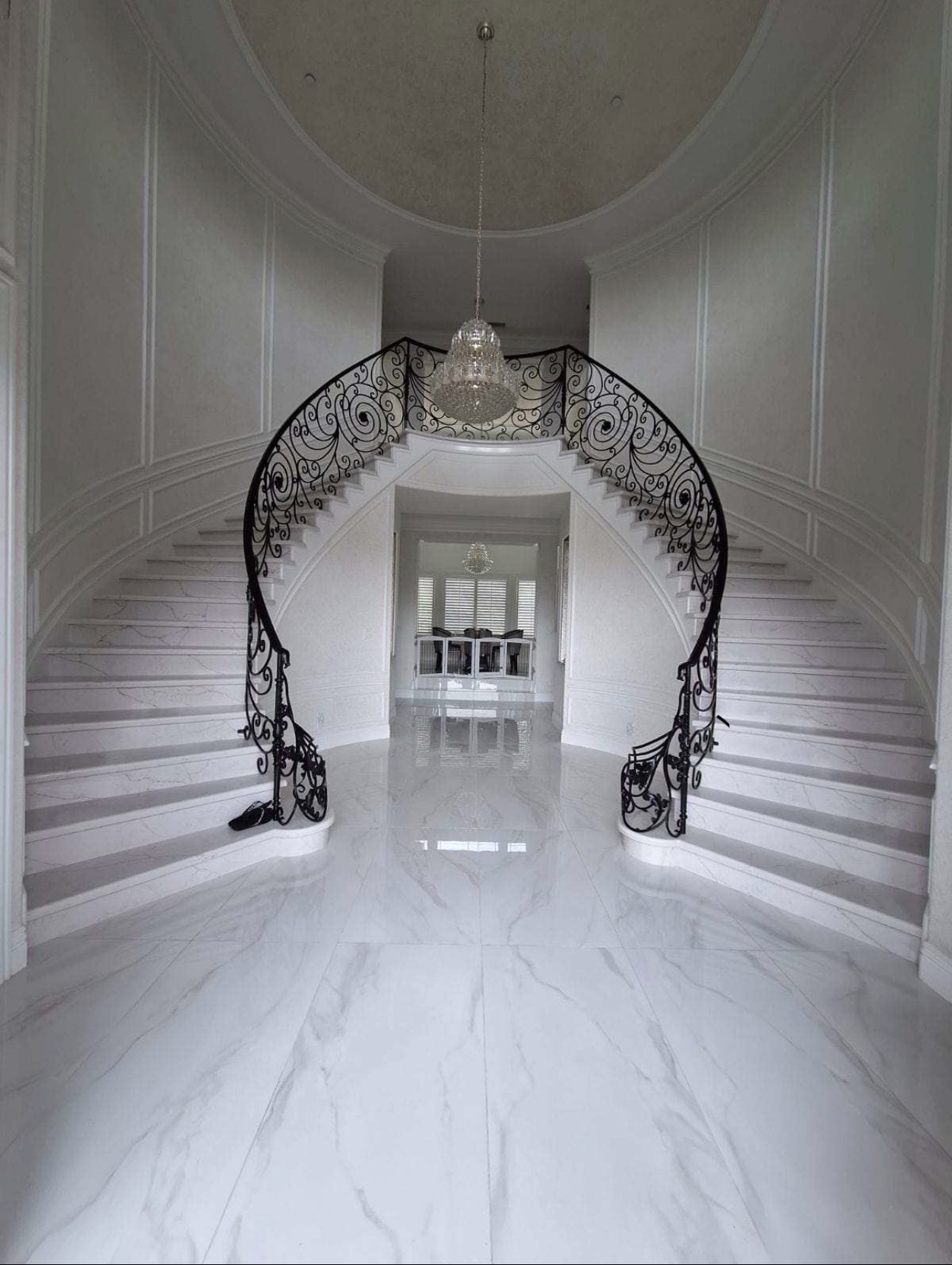 Custom marble staircase with wrought iron railing — HMM Construction